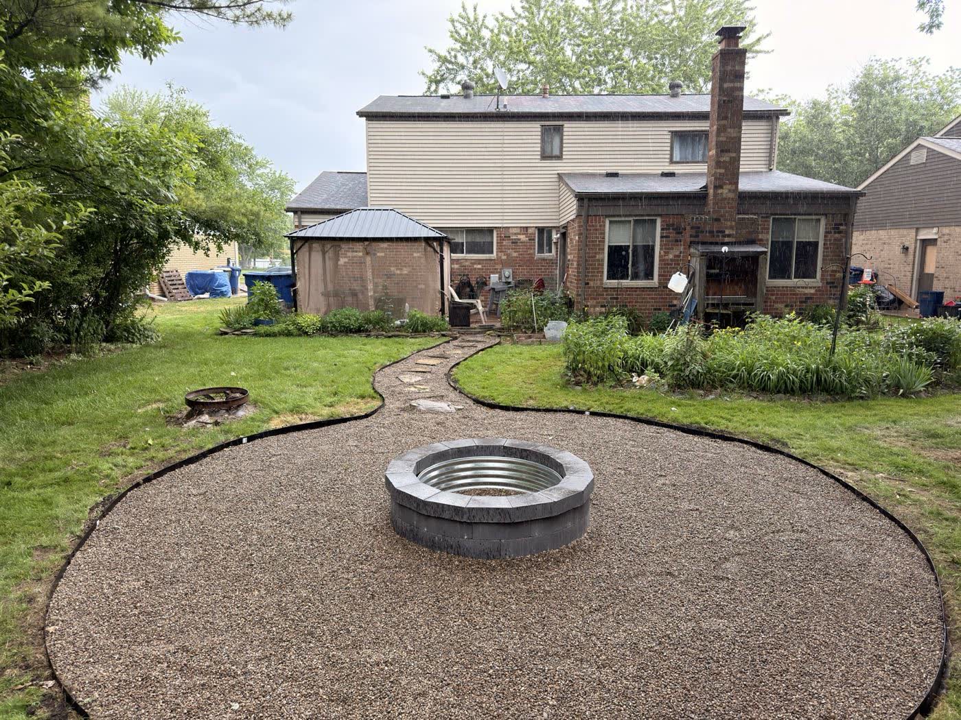 Custom fire pit set in a gravel patio