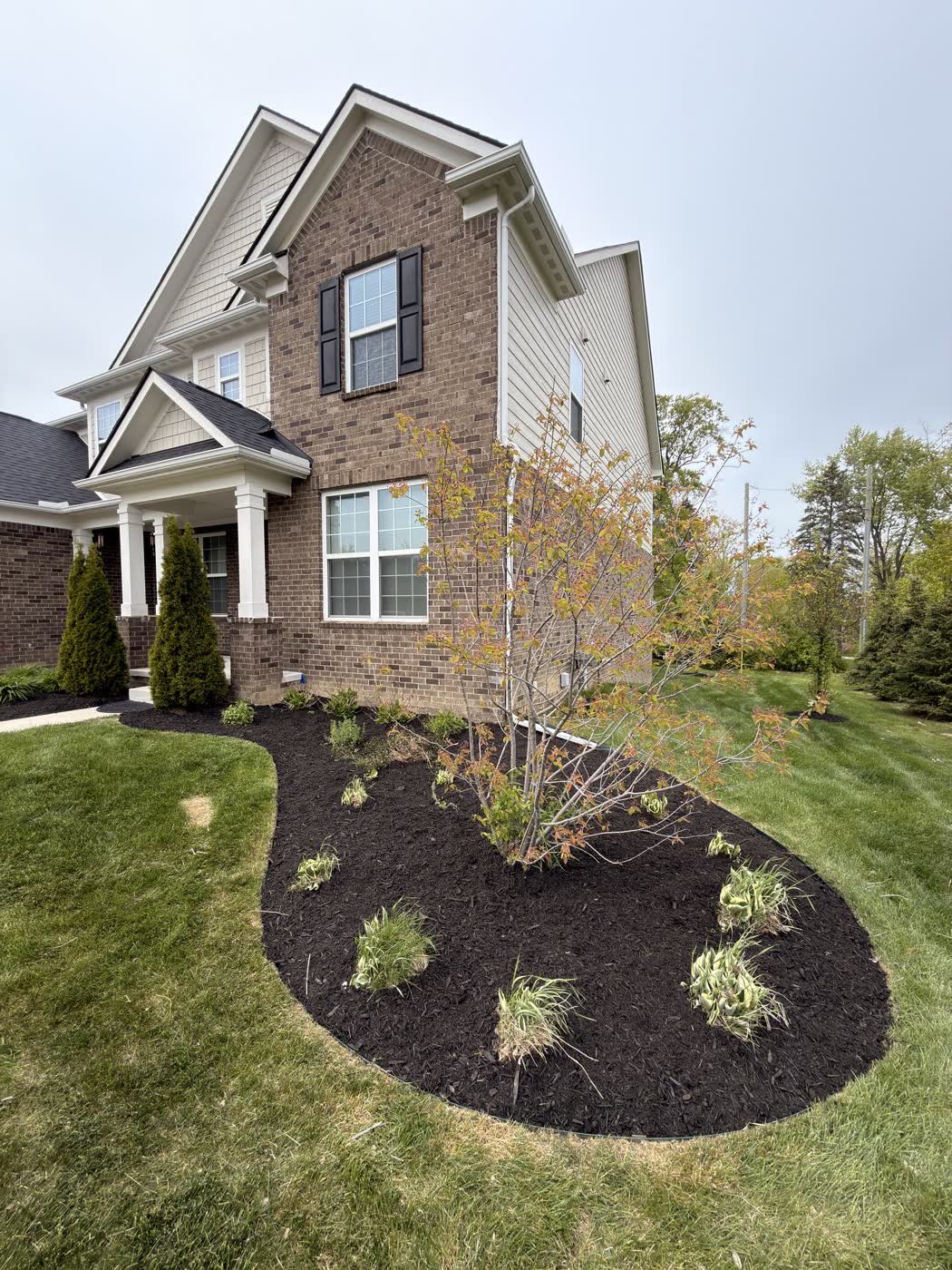 Front yard bed with boulder border and fresh mulch
