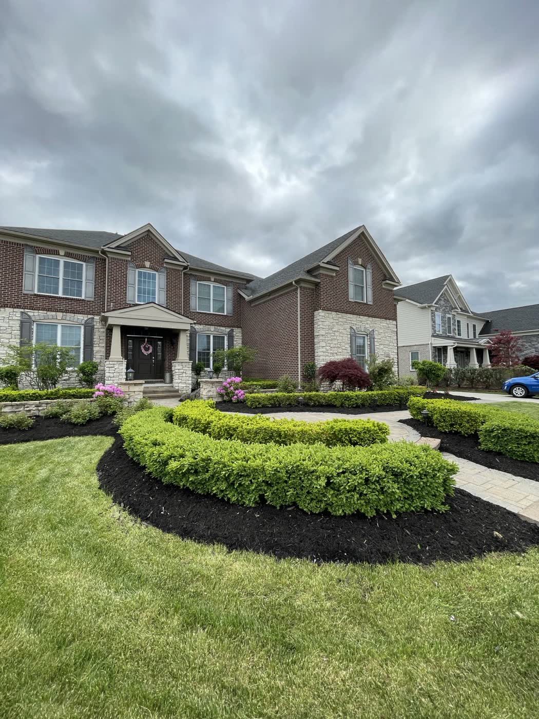 Front yard with a long curved mulch bed following the walkway