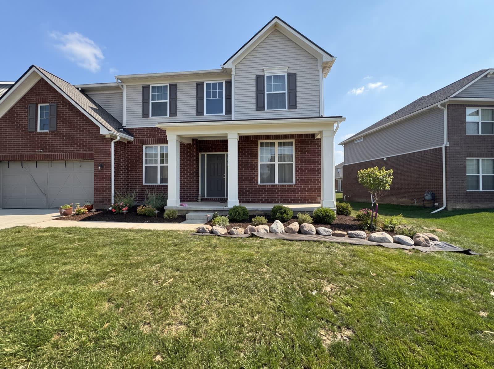 The same front yard planted with shrubs and perennials and finished with fresh hardwood mulch