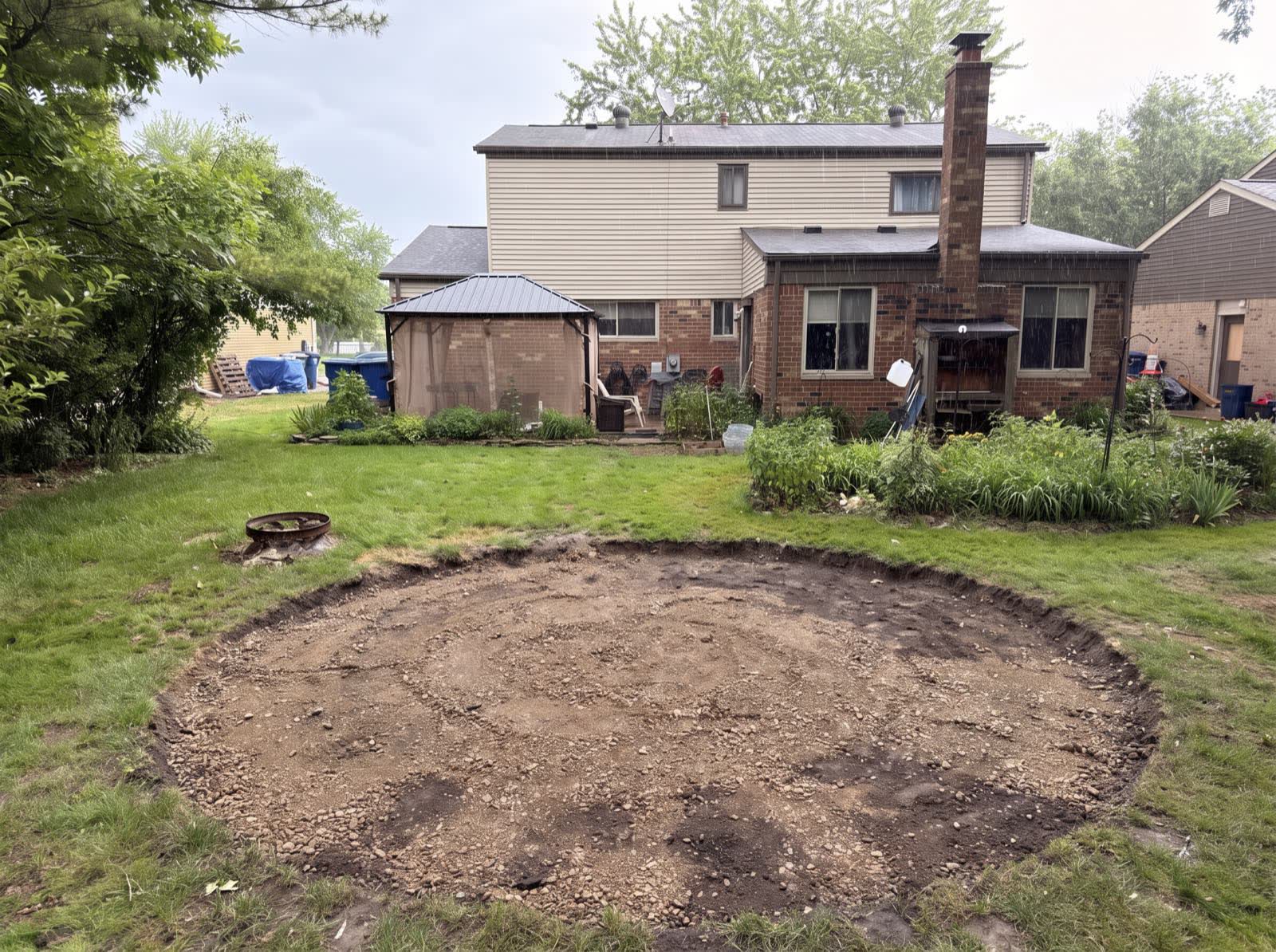 Mid-build: the patio circle excavated and filled with compacted base gravel